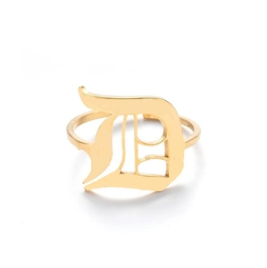 Detail shot of golden Gothic letter D cutout on a slim adjustable open ring band