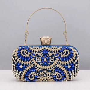 Detail of royal blue rhinestone evening clutch with gold filigree and ring handle