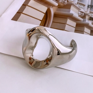 Close-up of vintage textured silver cuff bracelet with organic hollow design and mirror finish