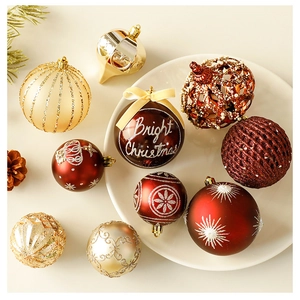 Detail of red and gold Christmas ornaments with Bright Christmas lettering and pine cones