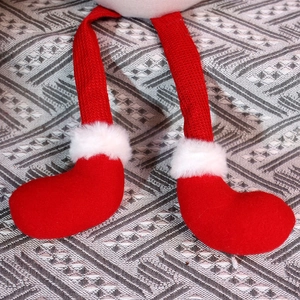 Détail macro de jambes en tricot de Noël et bottes rouges avec bordure en peluche