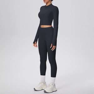 Détail d'un ensemble de yoga noir avec passe-pouces aux manches et legging de sport taille haute