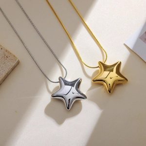 Detailed view of 3D star pendants on delicate snake chains in silver and gold finishes