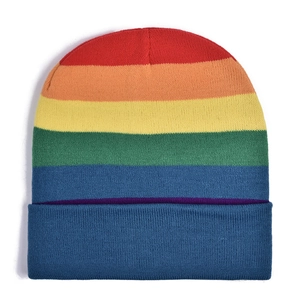 Detailed close-up of rainbow striped knit beanie showing fine warm texture and blue folded cuff