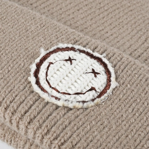 Khaki winter knit beanie featuring a double-cuff and embroidered smiley face patch