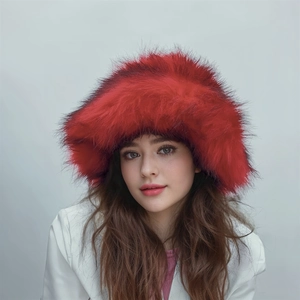 Close-up of fluffy red faux fur winter hat showcasing thick plush texture and vibrant color