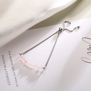 Detail of adjustable silver chain bracelet with natural pink crystal beads and bolo clasp