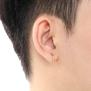 Close-up of a minimalist 18K gold stainless steel hoop earring worn by a male model