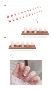 Detail of pink gradient press-on nails with 3D white flowers and sparkling rhinestones