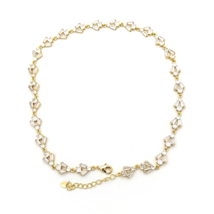 Close-up of gold heart flower necklace with sparkling cubic zirconia on white background