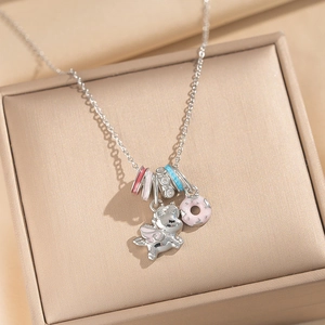 Enamel unicorn and donut pendant necklace displayed in a gold luxury jewelry box