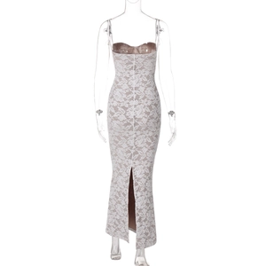 Detail view of white lace dress back featuring beige lining, lacing, and elegant slit
