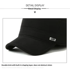 Detail view of the reinforced brim and metal T-S logo on the black cotton army cap
