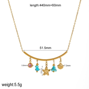 Gold shell starfish necklace with turquoise beads and pink charm on white background