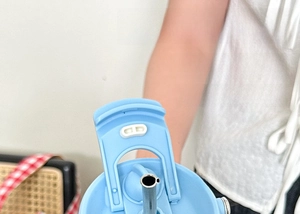 Close-up of light blue dual-purpose lid with direct drink and straw holes for tumbler