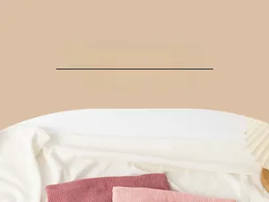 Detailed texture of corduroy clutch bag available in dark red and light pink hues