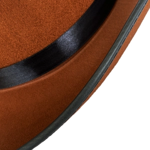 Detailed macro view of dark brown wool fedora with black leather binding and satin ribbon