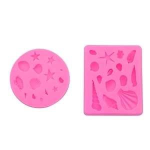 Pink silicone marine life molds featuring detailed starfish and seashell shapes for cake decor