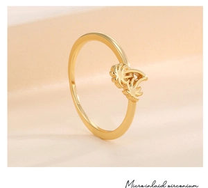 Close-up of golden palm tree ring detailing micro-inlaid zirconium and craft