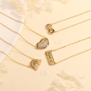 Detail of gold necklaces with colorful zircon infinity, lips, and rainbow pendants