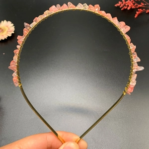 Detail of pink crystal stones hand-wrapped with gold wire on a bridal crown headband