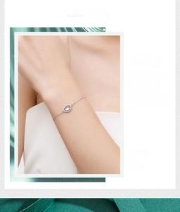 Detail of S925 sterling silver moonstone bracelet on a model with elegant silk background