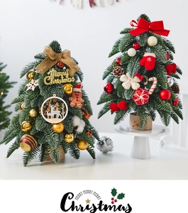 Detail of mini snowy Christmas trees with wooden bases, red bows and festive ornaments