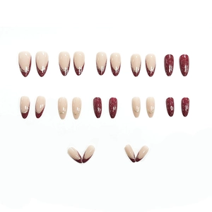 Elegant almond press-on nails with burgundy and nude French tip design and gold foil