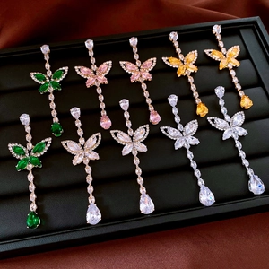 Detail of butterfly drop earrings with zircon crystals in multiple elegant colors
