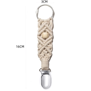 Detail view of macrame hat clip with woven cotton rope and metal clasp for outdoor travel