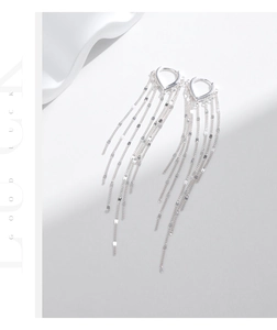 Detail of s925 silver V-shaped hoop earrings with dangling long tassels and shiny metal sequins