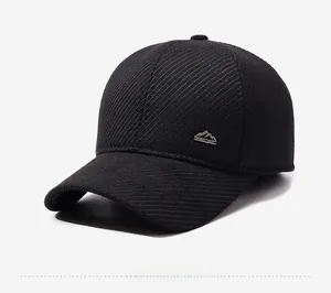 Detail of winter baseball cap featuring thick striped fabric and metal sport logo