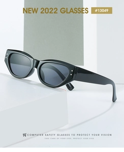 Close-up of black cat-eye glasses with silver dot accents on a geometric white stand