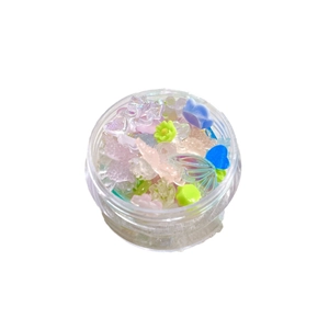 Assorted resin nail art charms featuring camellia flowers and butterflies in a clear jar
