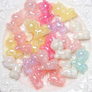 Macro shot of colorful pearlescent resin unicorn charms for DIY jewelry and crafts