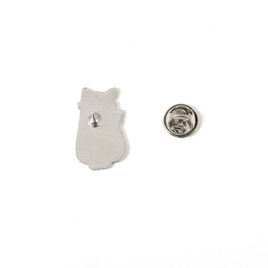 Rear view of white cat enamel pin showing silver metal back and butterfly clutch