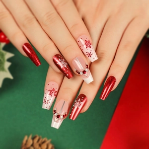 Christmas snowflake press-on nails in festive red and white with glitter and rhinestones