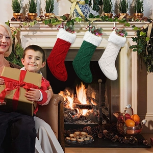 Three plush knitted Christmas stockings in red, green, and white hanging on a festive fireplace
