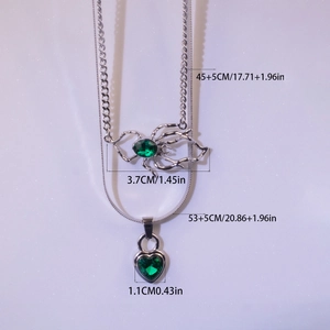 Detailed size view of layered silver necklace with green emerald heart and spider pendants