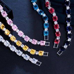 Detail of square zircon bracelets in white yellow pink blue and red with gold plating