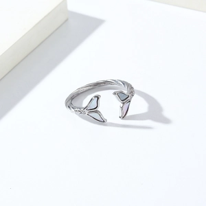 Detailed close-up of a silver fishtail ring featuring white shell inlay and twisted band