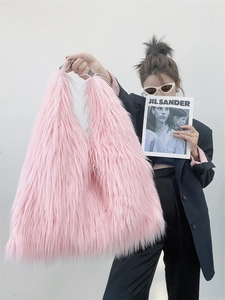 Fashionable pink faux fur tote bag styled with black blazer for a Y2K aesthetic look