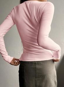 Detailed back view of pink ribbed long-sleeve knit sweater with slim fit design