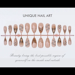Detail view of 24pcs long almond press-on nails with 3D floral carving and leopard print