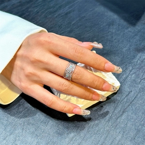 Retro geometric multi-layer silver wavy ring with small blue stones on female hand