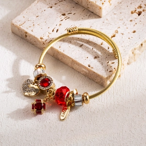 Golden twist bangle bracelet with heart swan charm and ruby-colored beads decoration