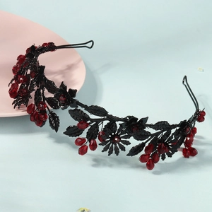 Detail of Gothic branch headband with red crystals on a pink plate background