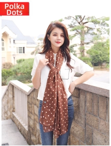 Close-up of lightweight brown scarf with beige polka dot print and sheer fabric texture