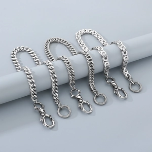 Detailed view of stainless steel Cuban, twisted, and Byzantine style trouser chains