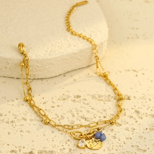 Double-layer gold titanium bracelet with teardrop zircon and pearl charms on stone